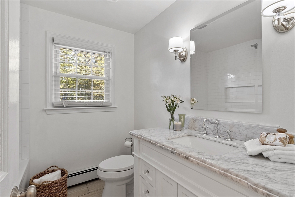 6 Gray Road Andover, MA 01810 - Photo 23 of 36 a bathroom with a granite countertop sink a toilet and a mirror