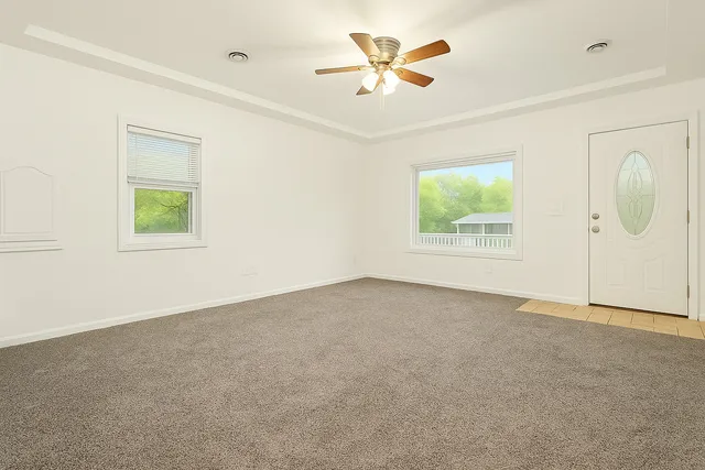 an empty room with windows and closet