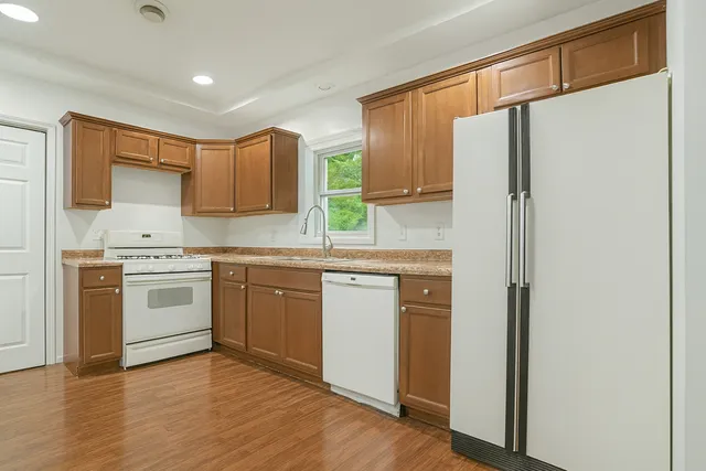 a kitchen with a white cabinets and white appliances
