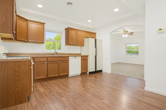 a kitchen with a sink cabinets and wooden floor