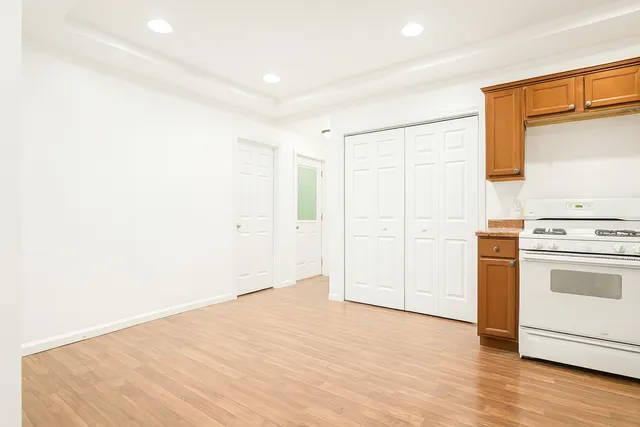 a view of a kitchen with wooden floor and a sink