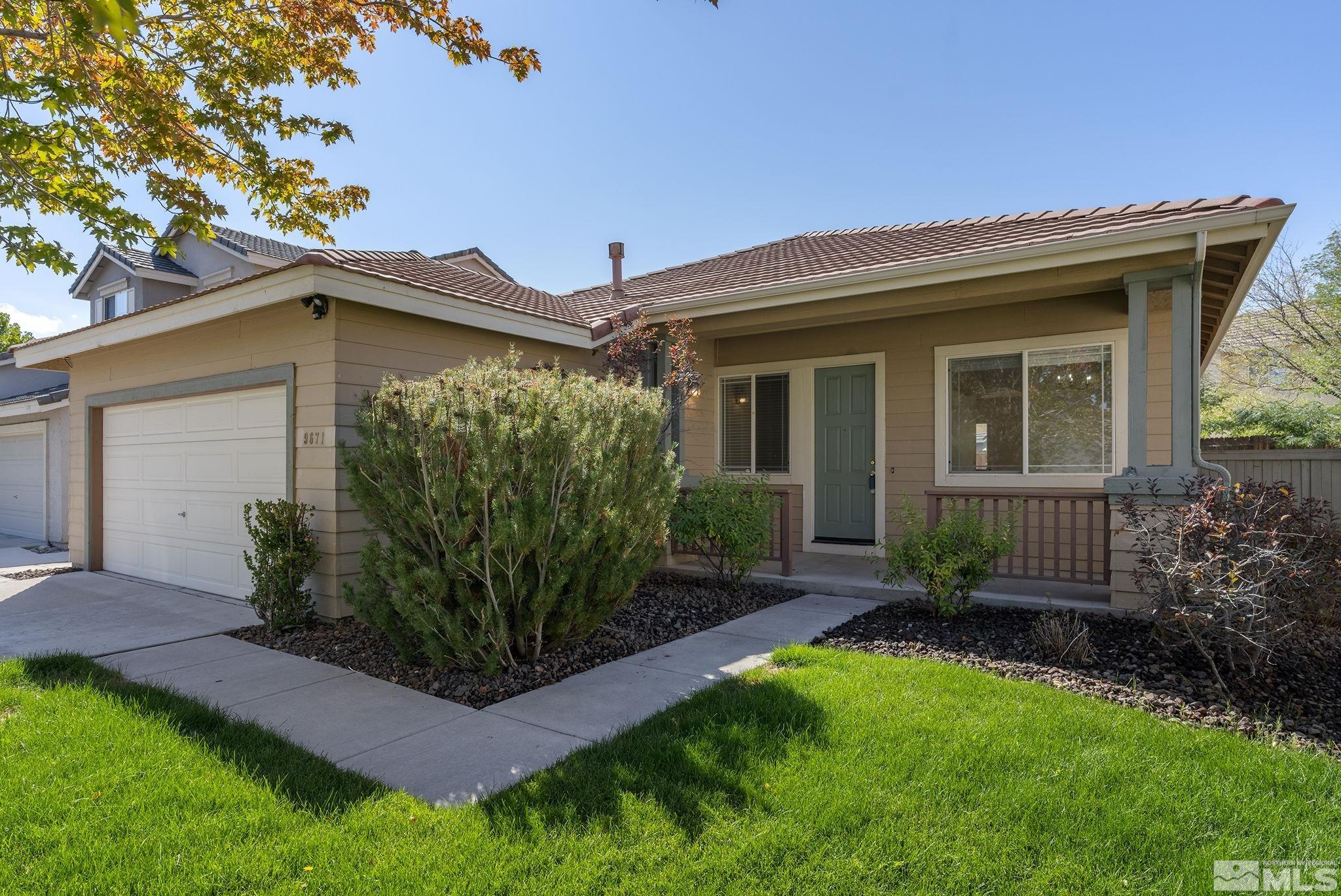 9671 Comanche Moon Drive Reno, NV 89521 - Photo 1 of 18 a view of a house with a yard and plants