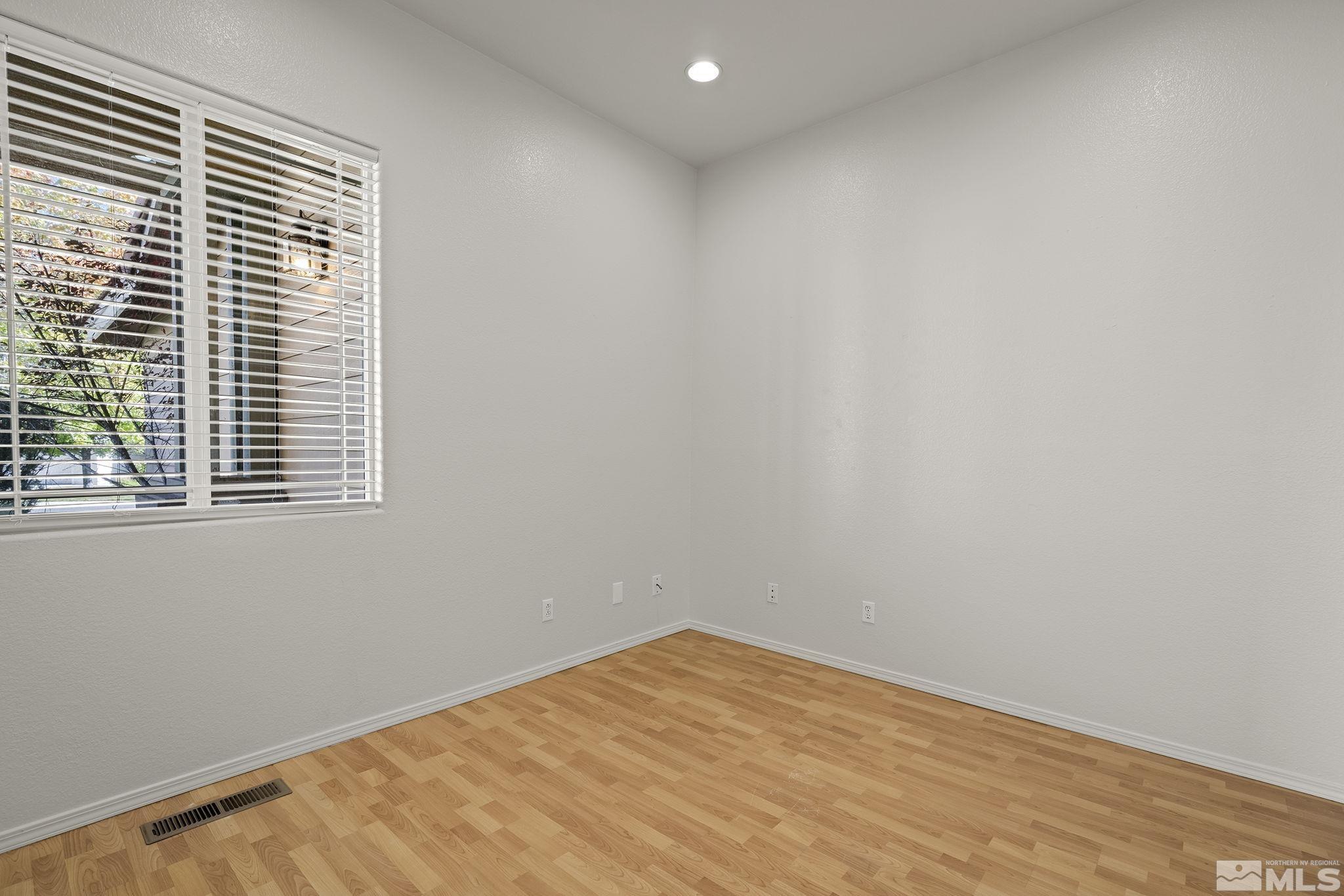 9671 Comanche Moon Drive Reno, NV 89521 - Photo 12 of 18 a view of empty room with wooden floor