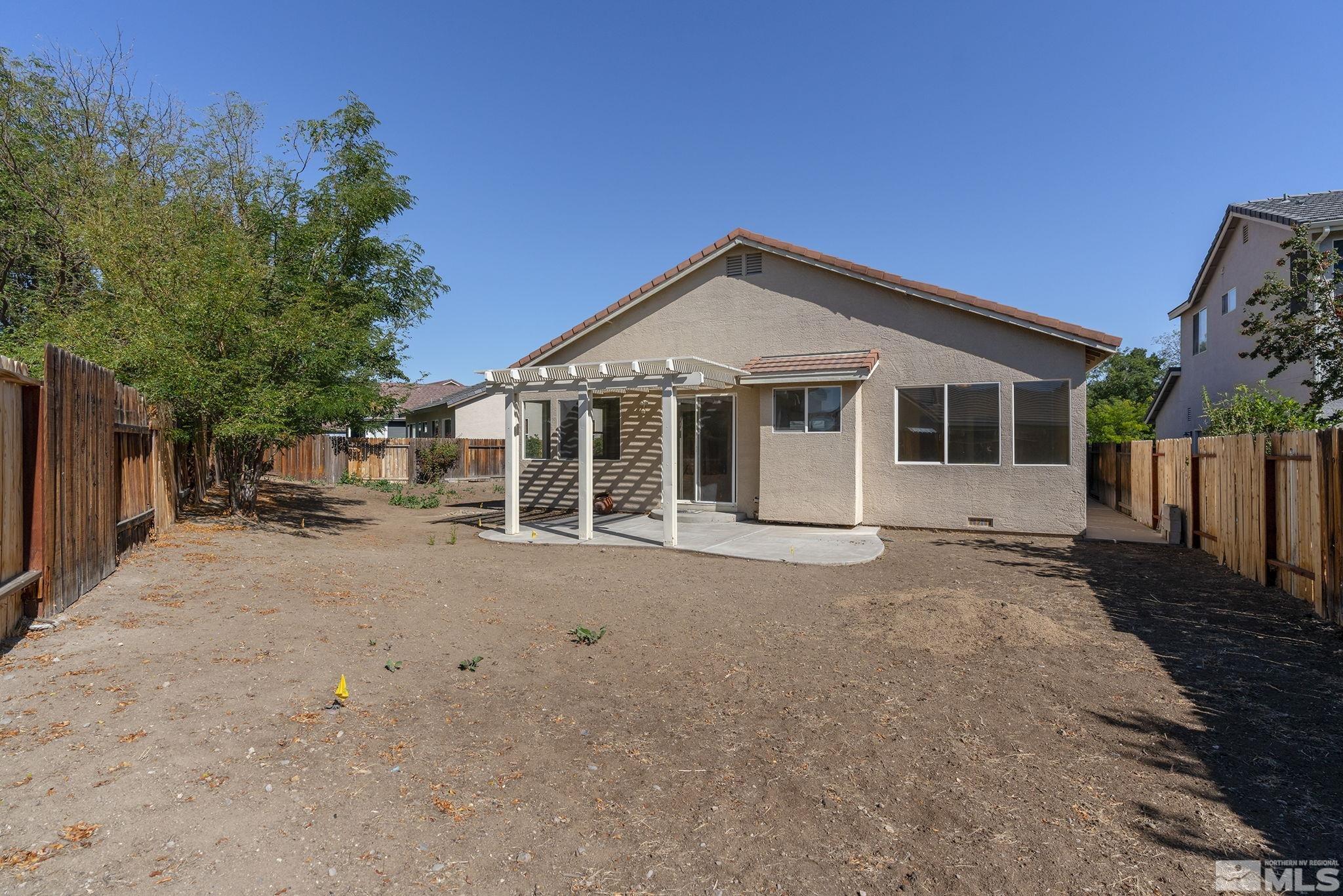 9671 Comanche Moon Drive Reno, NV 89521 - Photo 18 of 18 a view of a house with backyard and a tree