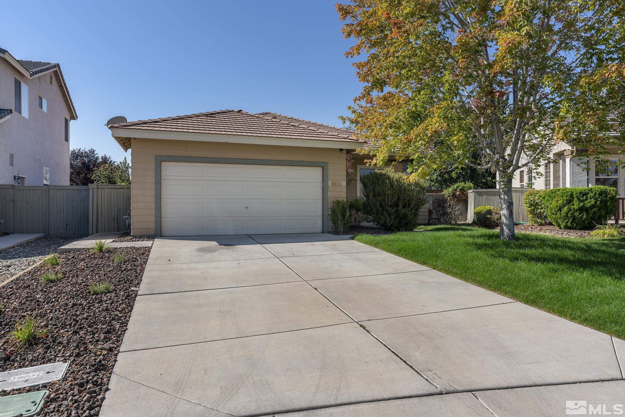 9671 Comanche Moon Drive Reno, NV 89521 - Photo 2 of 18 a front view of a house with a yard and garage
