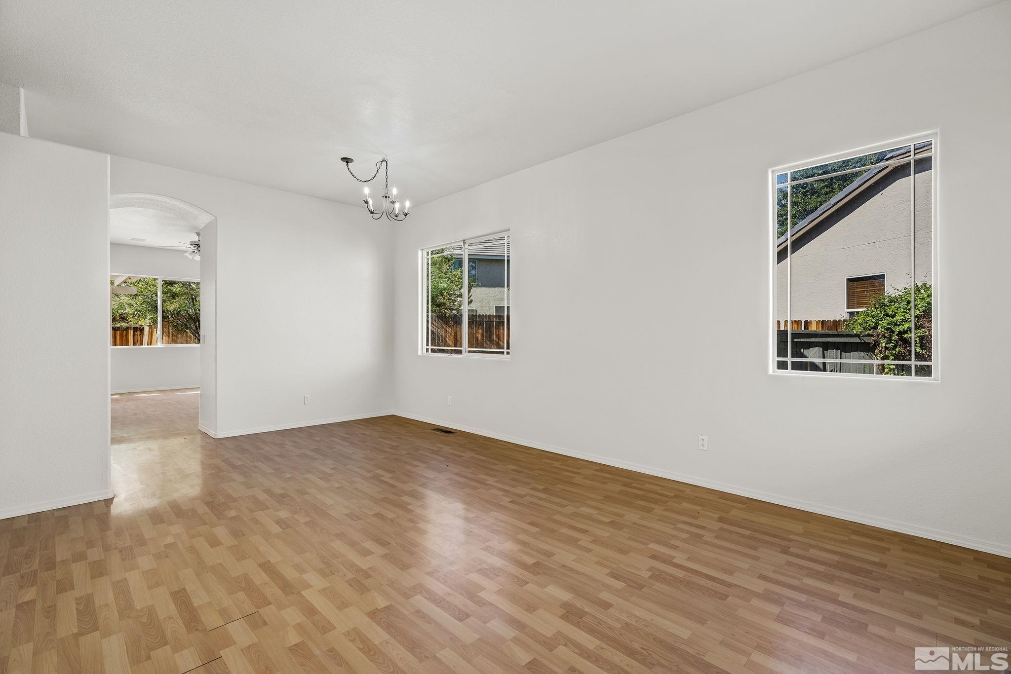 9671 Comanche Moon Drive Reno, NV 89521 - Photo 3 of 18 wooden floor in an empty room with a window