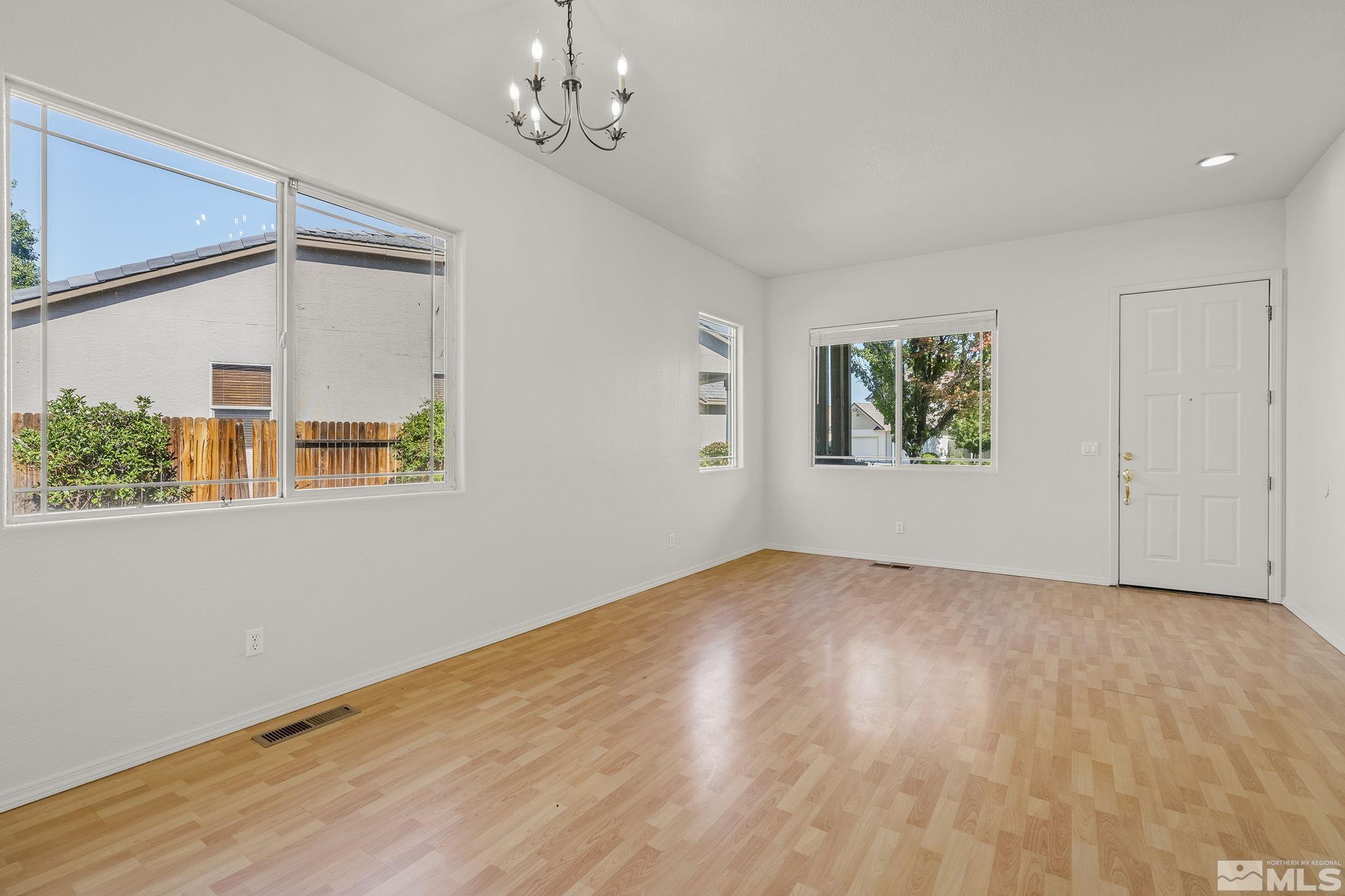9671 Comanche Moon Drive Reno, NV 89521 - Photo 5 of 18 a view of empty room with wooden floor and fan