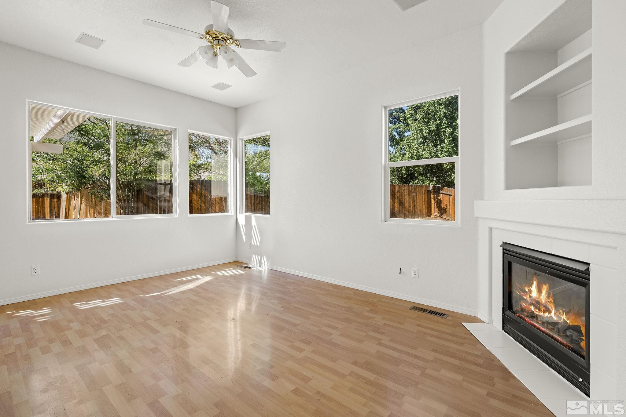 9671 Comanche Moon Drive Reno, NV 89521 - Photo 6 of 18 a view of an empty room with a fireplace and a window