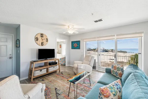 a living room with furniture a rug and a flat screen tv
