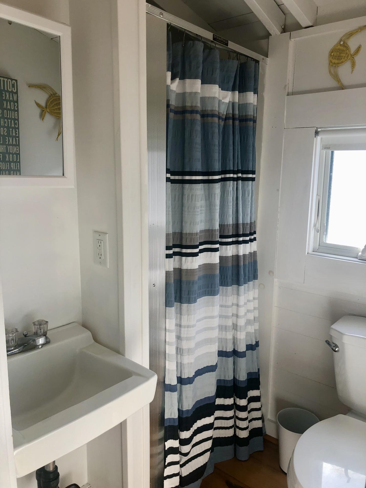 503 Shore Road, Unit 26 Truro, MA 02666 - Photo 12 of 17 a bathroom with a sink and a toilet