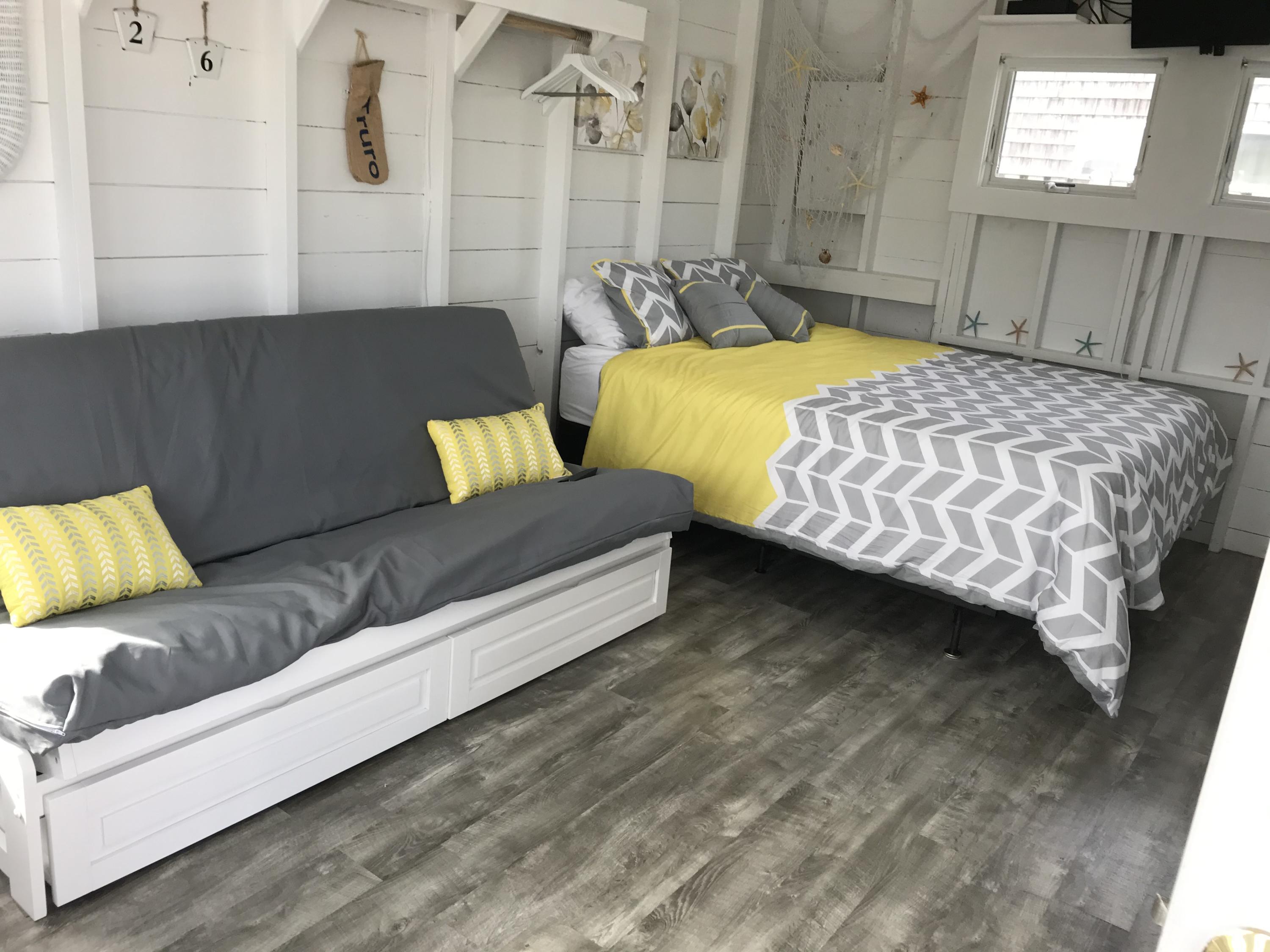 503 Shore Road, Unit 26 Truro, MA 02666 - Photo 5 of 17 a bedroom with a bed couch and a night stand