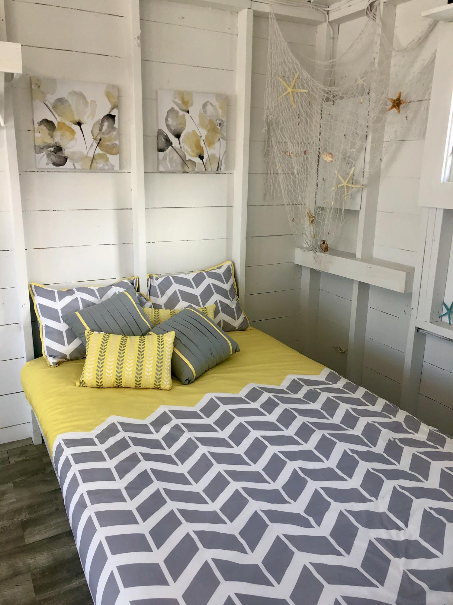 503 Shore Road, Unit 26 Truro, MA 02666 - Photo 6 of 17 a bedroom with a bed and painting on the wall