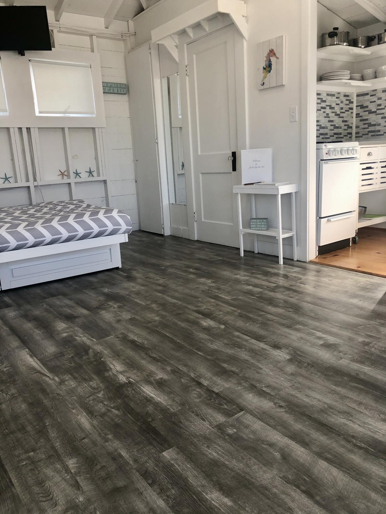 503 Shore Road, Unit 26 Truro, MA 02666 - Photo 8 of 17 a view of a bedroom with wooden floor and chair
