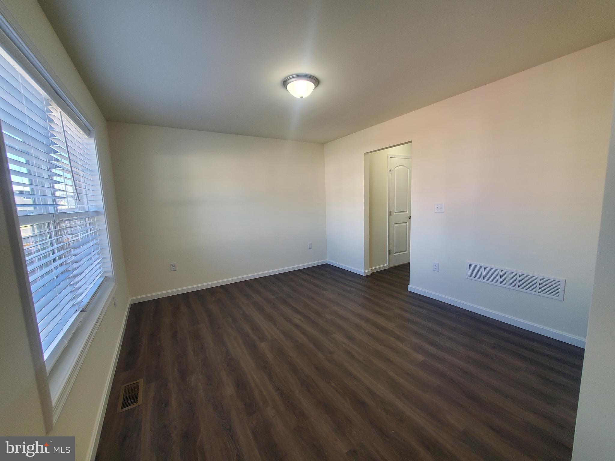 205 Cilento Drive Magnolia, DE 19962 - Photo 23 of 46 a view of an empty room with wooden floor and a window