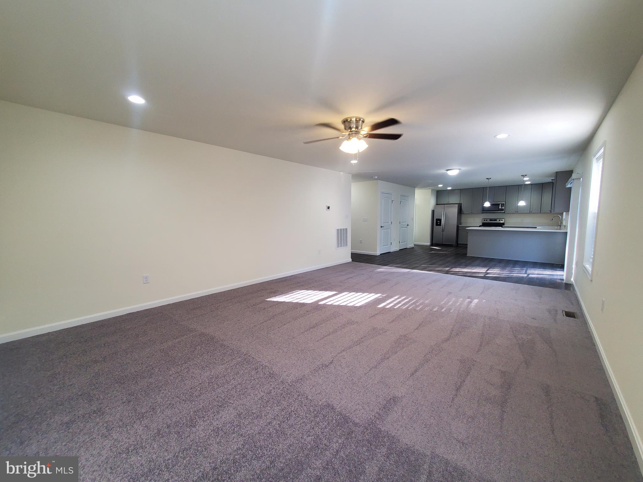205 Cilento Drive Magnolia, DE 19962 - Photo 26 of 46 an empty room with a window and a ceiling fan