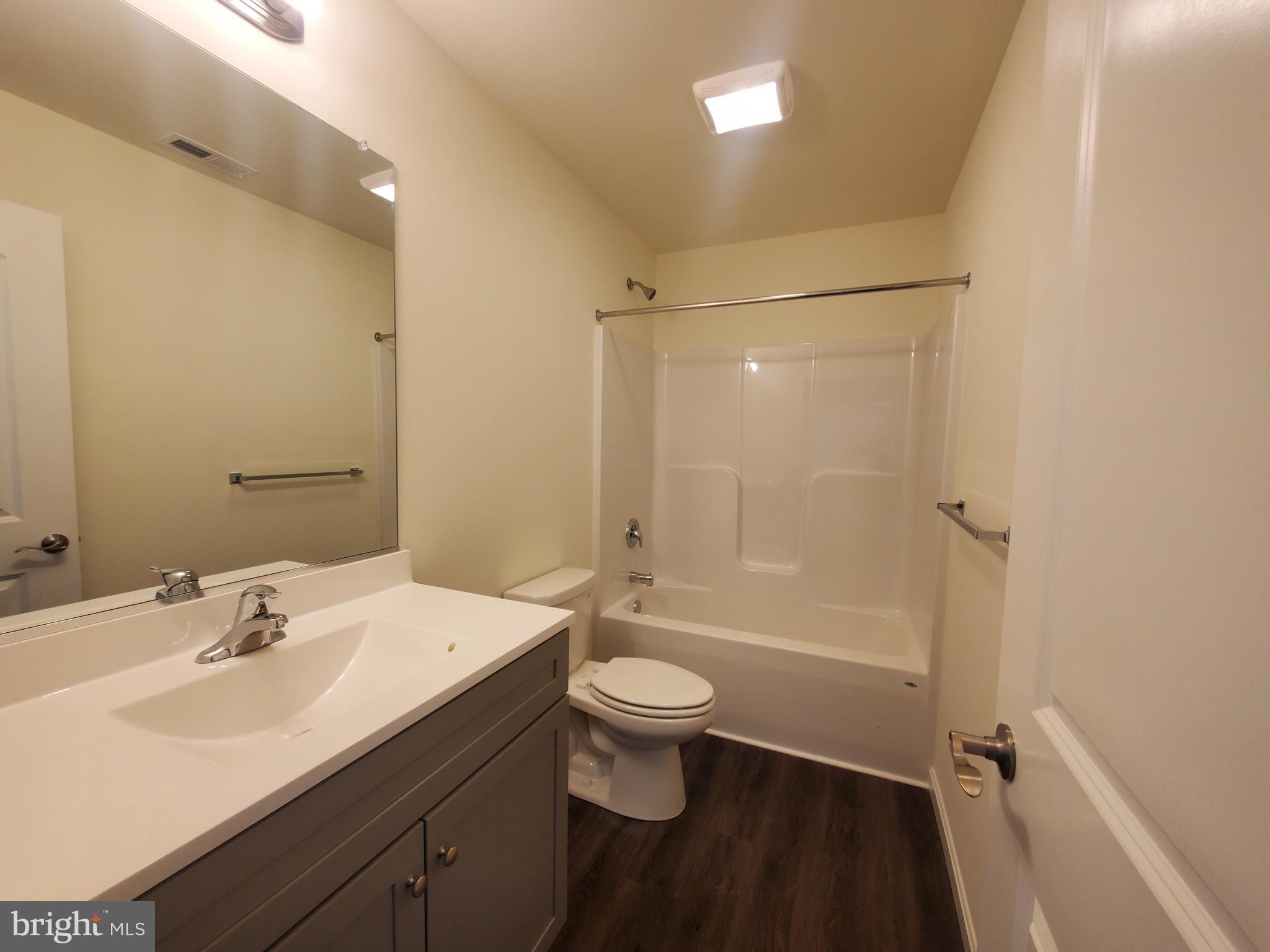 205 Cilento Drive Magnolia, DE 19962 - Photo 34 of 46 a bathroom with a sink a toilet and shower