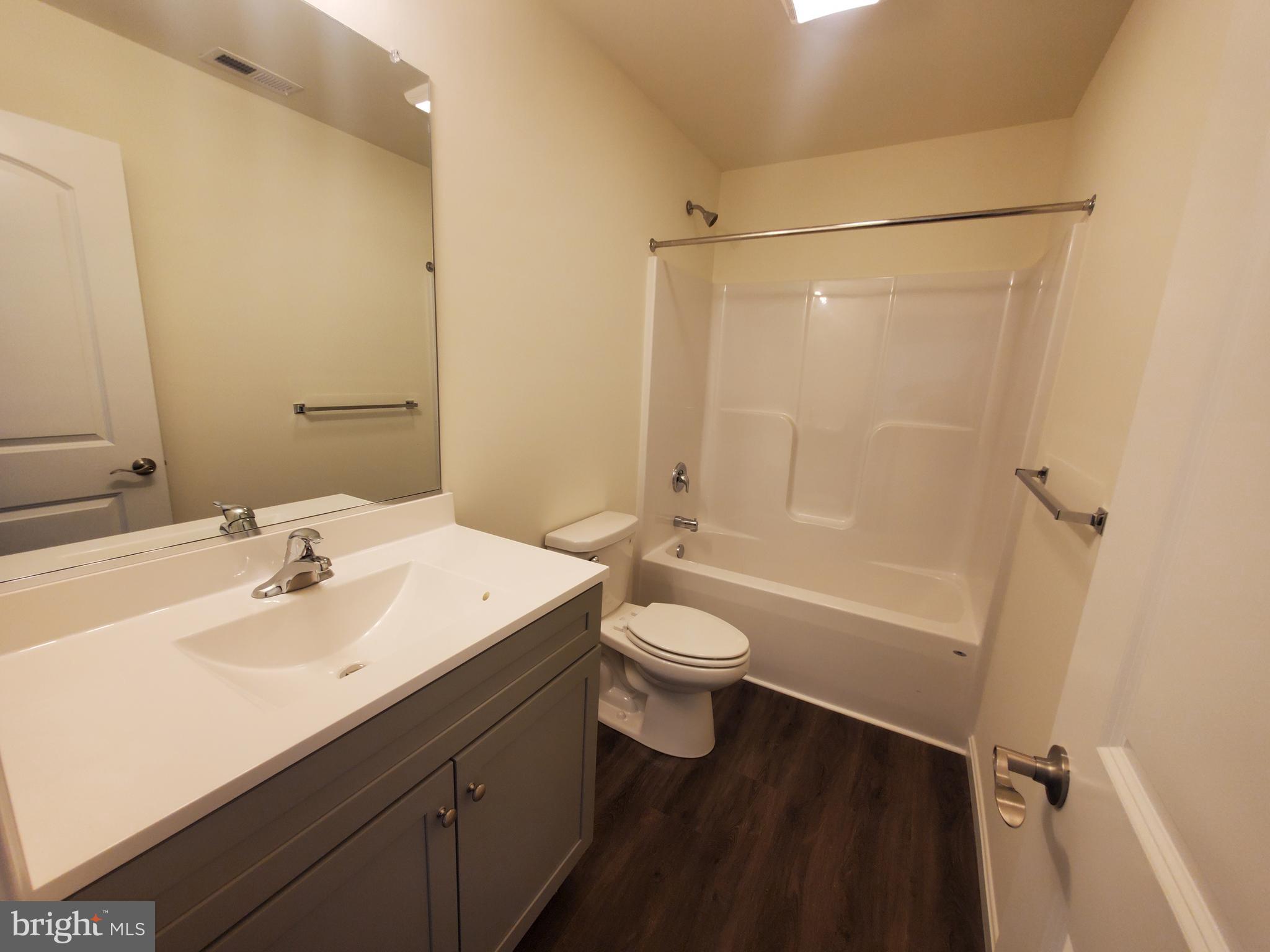 205 Cilento Drive Magnolia, DE 19962 - Photo 35 of 46 a bathroom with a sink a toilet and shower