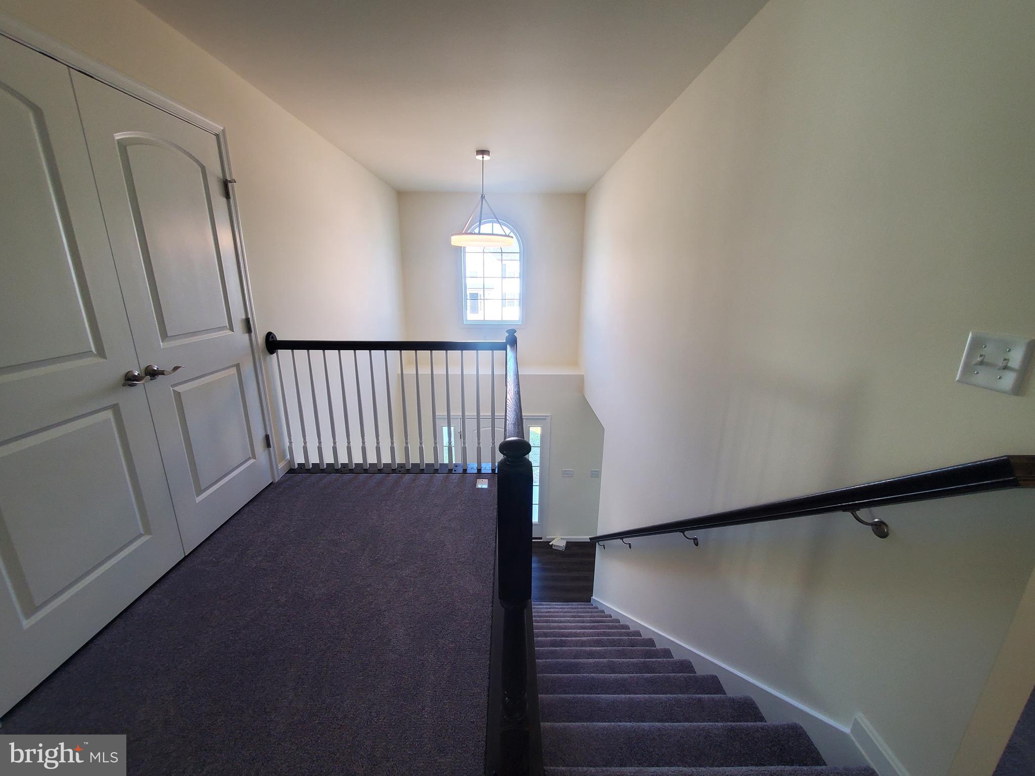 205 Cilento Drive Magnolia, DE 19962 - Photo 39 of 46 a view of a hallway with wooden floor and stairs
