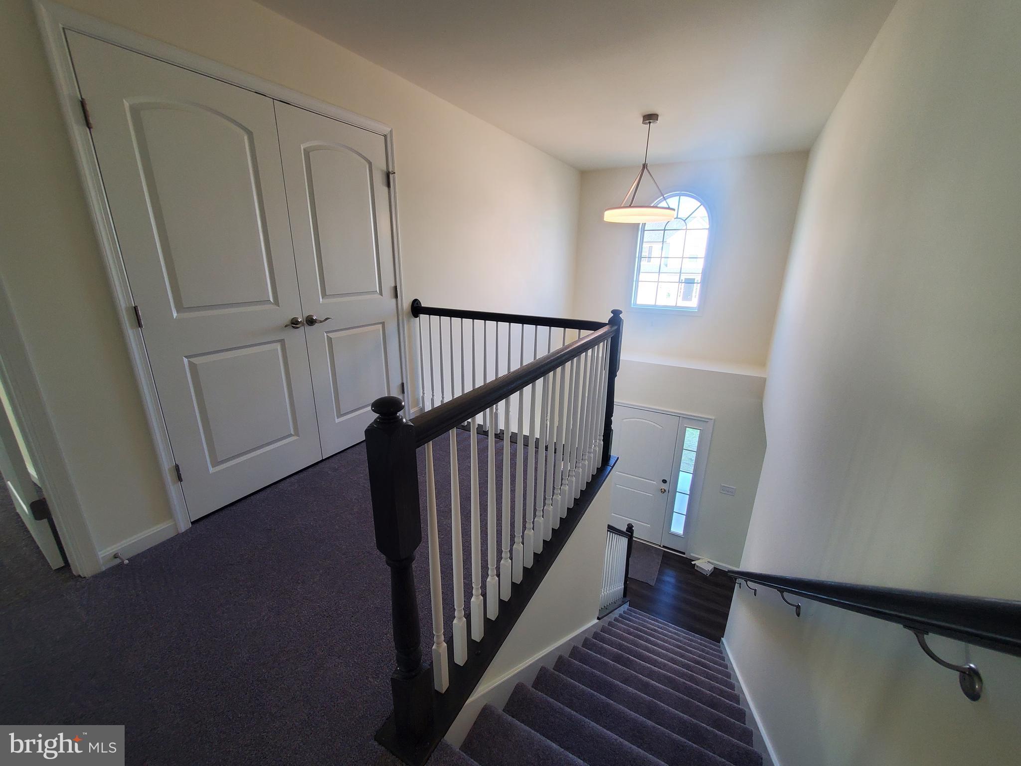 205 Cilento Drive Magnolia, DE 19962 - Photo 40 of 46 a view of a hallway with wooden floor and staircase