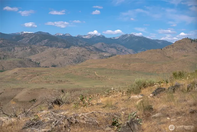 a view of mountain with sunset in background