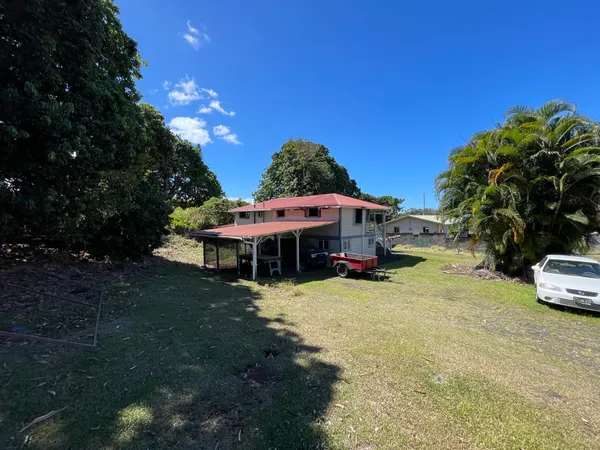 a view of a house with backyard porch and sitting area