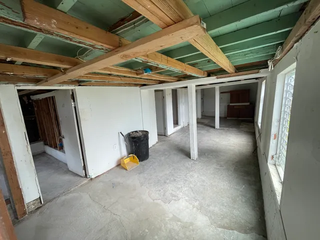 a view of a hallway with wooden walls