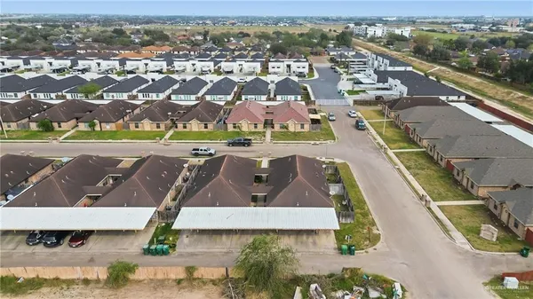 an aerial view of residential houses with outdoor space