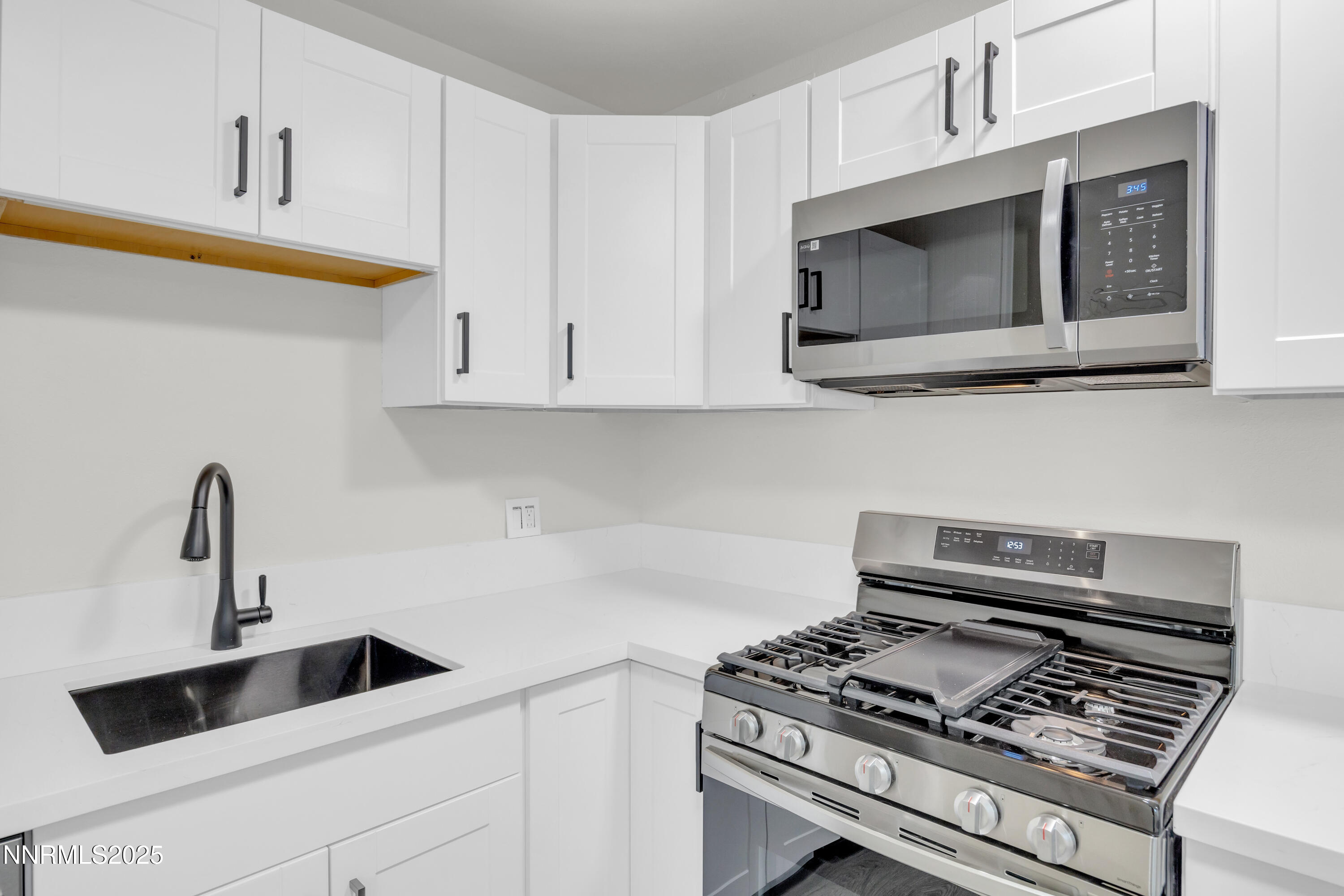 705 York Way Sparks, NV 89431 - Photo 4 of 17 a kitchen with a stove and a microwave