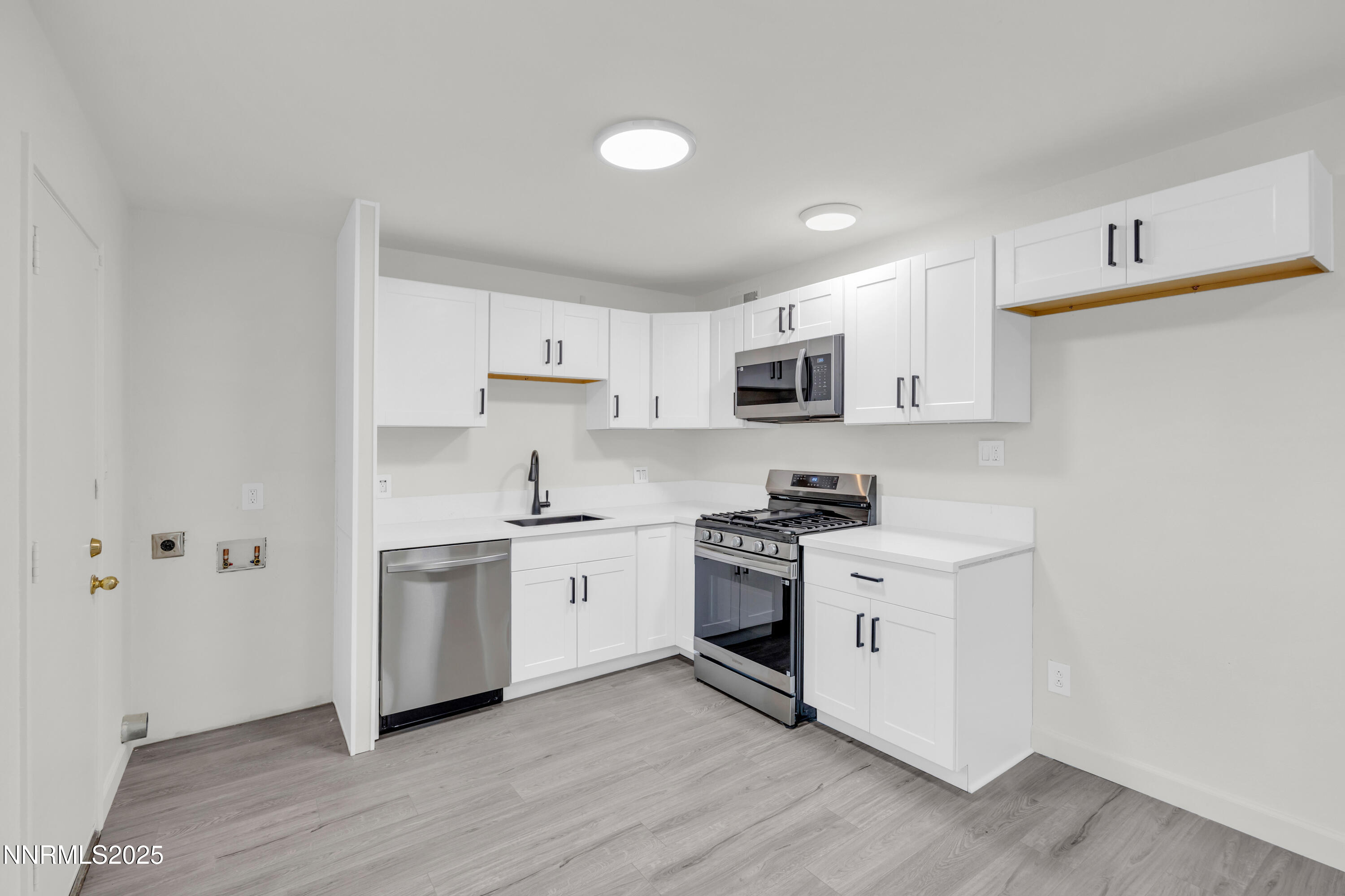 705 York Way Sparks, NV 89431 - Photo 5 of 17 a kitchen with stainless steel appliances granite countertop white cabinets a sink a stove a refrigerator and white cabinets