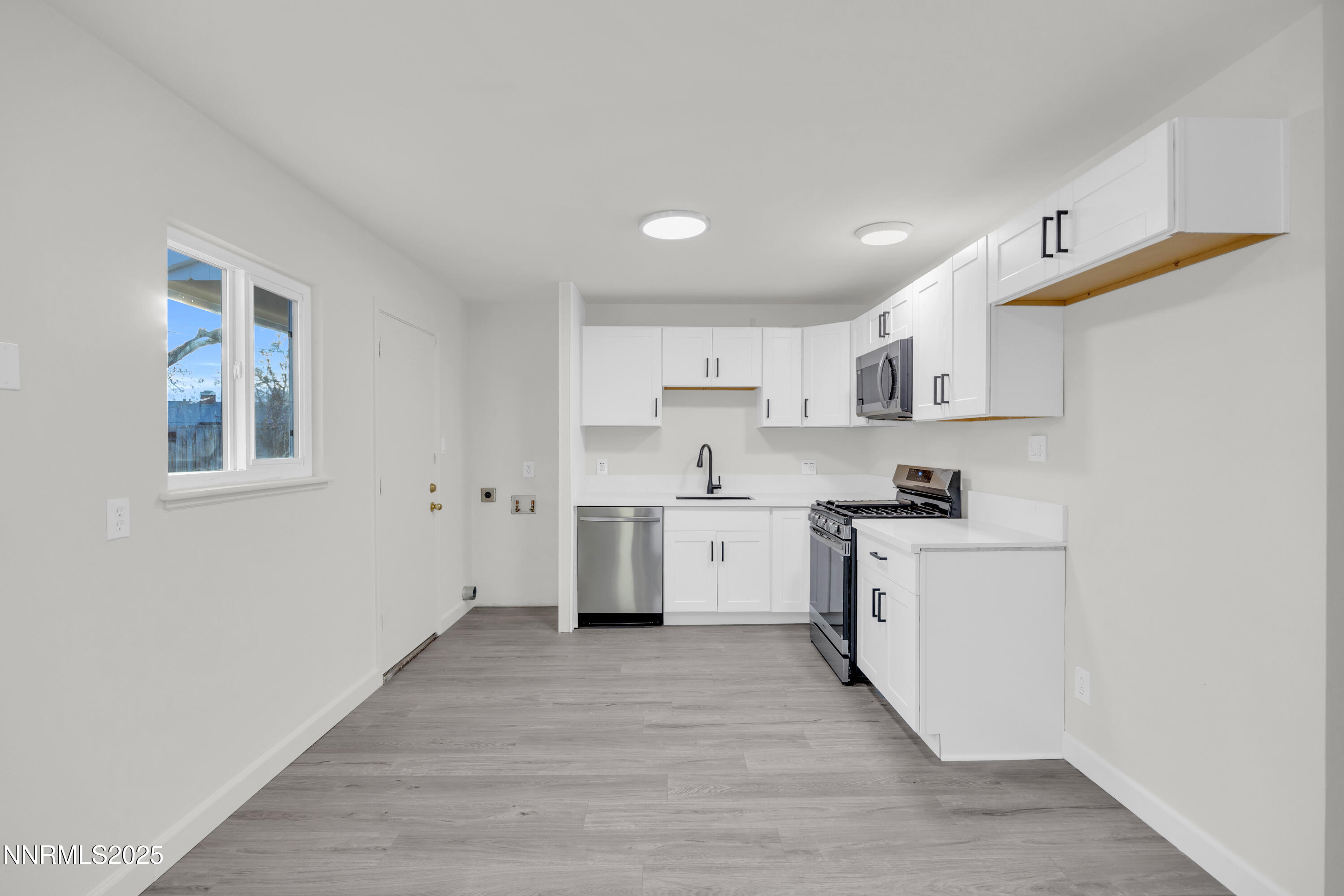 705 York Way Sparks, NV 89431 - Photo 6 of 17 a kitchen with cabinets wooden floor and a sink