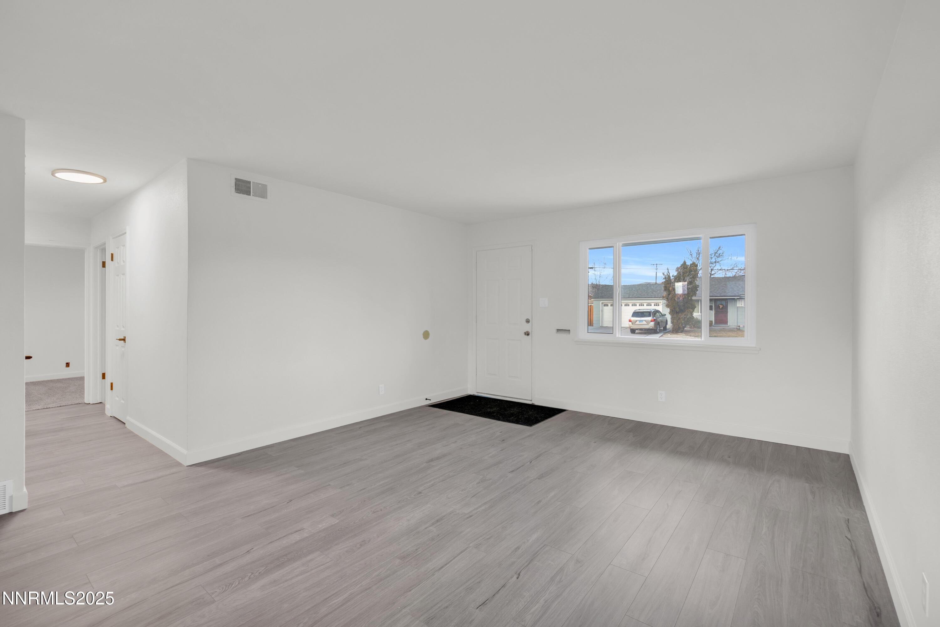 705 York Way Sparks, NV 89431 - Photo 7 of 17 an empty room with wooden floor and windows