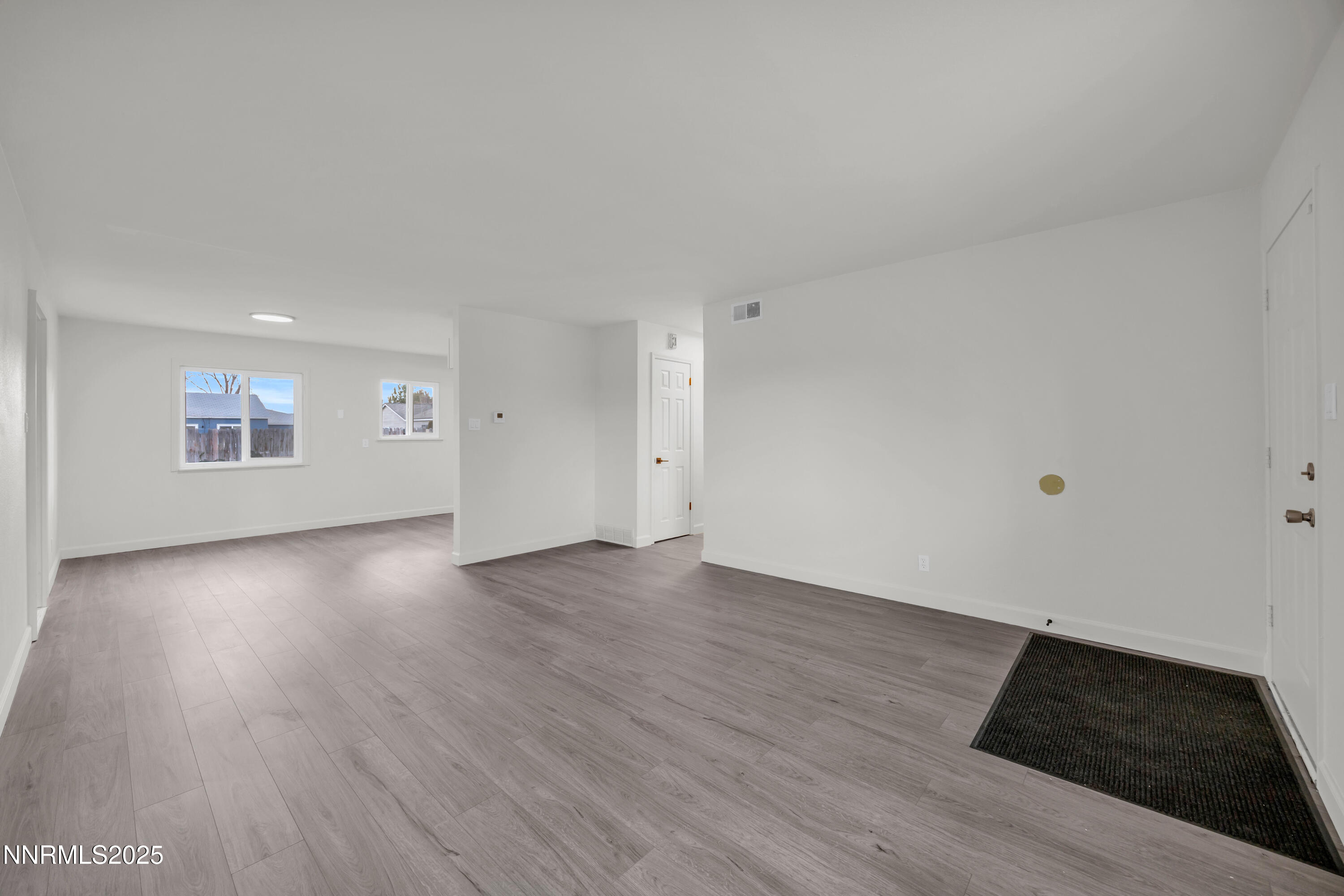705 York Way Sparks, NV 89431 - Photo 8 of 17 an empty room with wooden floor and windows