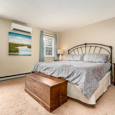 36 Atkins Road, Unit E2 Sandwich, MA 02537 - Photo 14 of 21 a bed sitting in a bedroom next to a window