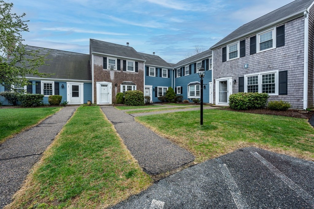 36 Atkins Road, Unit E2 Sandwich, MA 02537 - Photo 2 of 21 a front view of a house with a yard