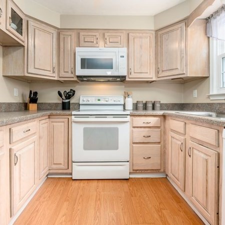 36 Atkins Road, Unit E2 Sandwich, MA 02537 - Photo 7 of 21 a kitchen with granite countertop white cabinets stainless steel appliances and sink