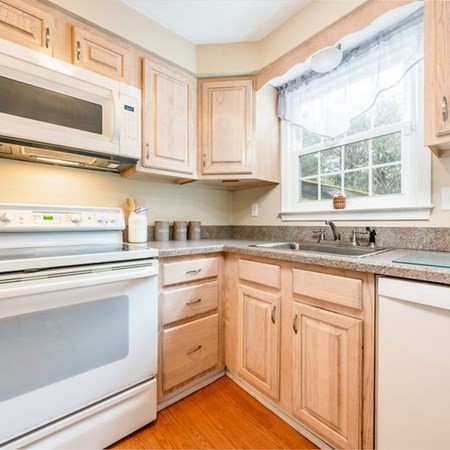 36 Atkins Road, Unit E2 Sandwich, MA 02537 - Photo 8 of 21 a kitchen with granite countertop white cabinets and white appliances