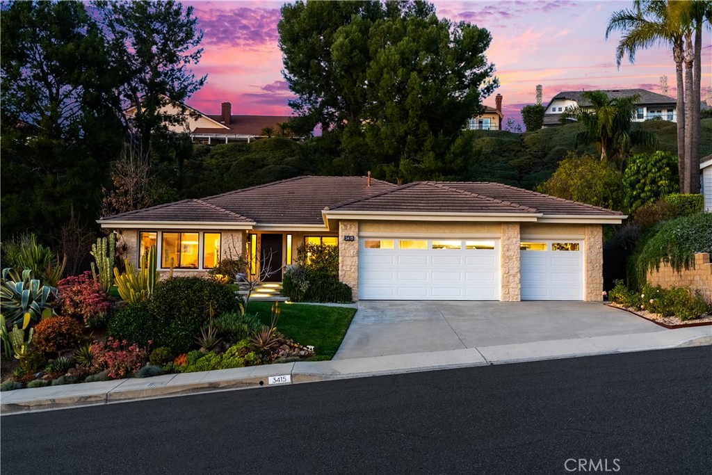 3415 East Ridgeway Road Orange, CA 92867 - Photo 1 of 1 a front view of a house with a yard and potted plants