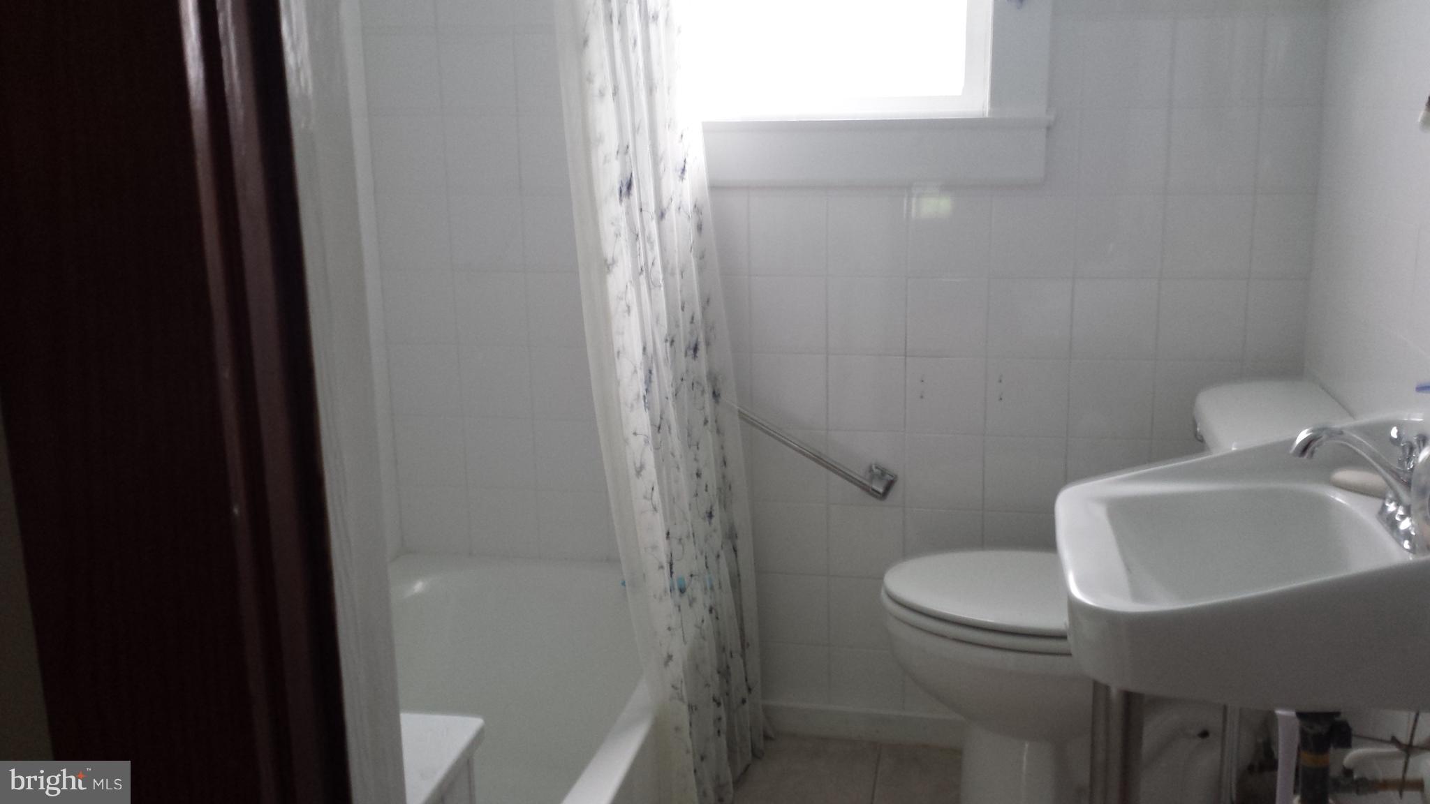 623 Edgewood Road Edgewood, MD 21040 - Photo 12 of 19 a bathroom with a sink toilet and shower