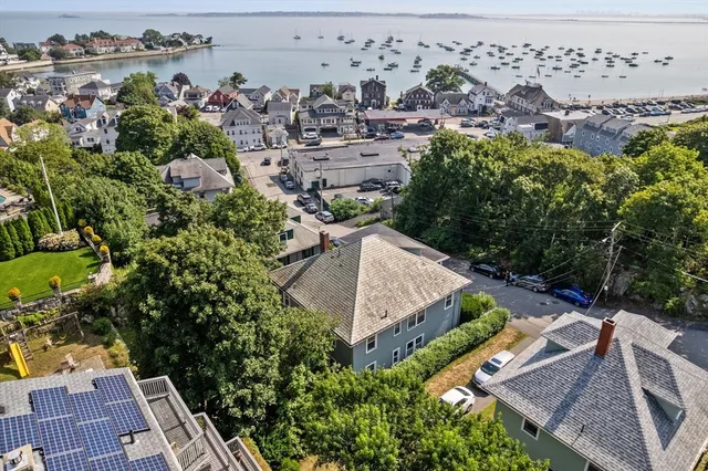 an aerial view of multiple houses with a yard