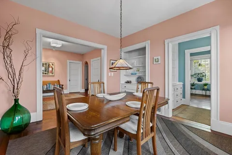 a dining room with furniture and a floor to ceiling window