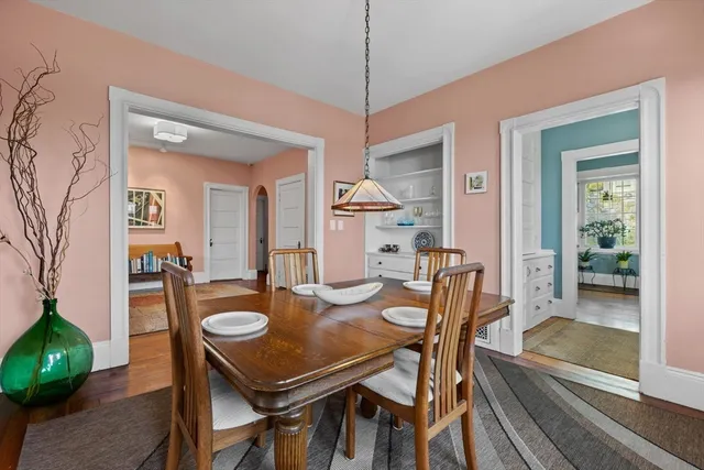 a dining room with furniture and a floor to ceiling window