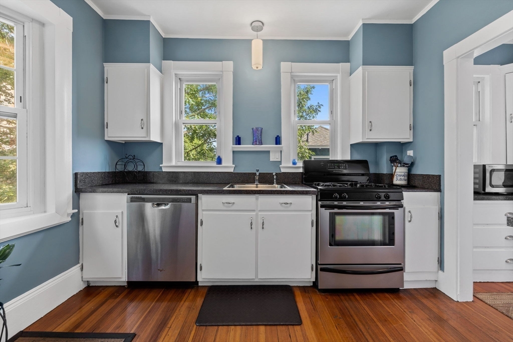13 Cedar Hill Terrace, Unit 2 Swampscott, MA 01907 - Photo 18 of 34 a kitchen with granite countertop a stove a sink and a microwave