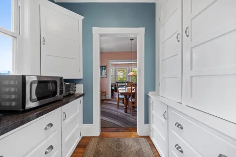 a kitchen with white cabinets and stainless steel appliances