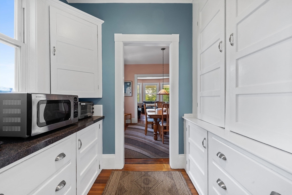 13 Cedar Hill Terrace, Unit 2 Swampscott, MA 01907 - Photo 19 of 34 a kitchen with white cabinets and stainless steel appliances