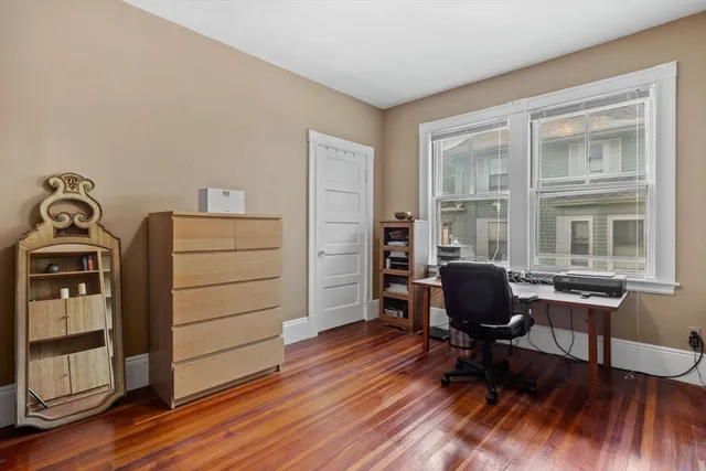 a view of a workspace with furniture and a window