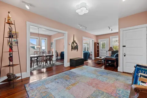 a living room with furniture and wooden floor