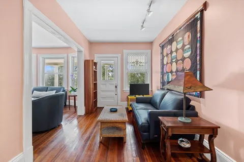 a living room with furniture a table and a flat screen tv