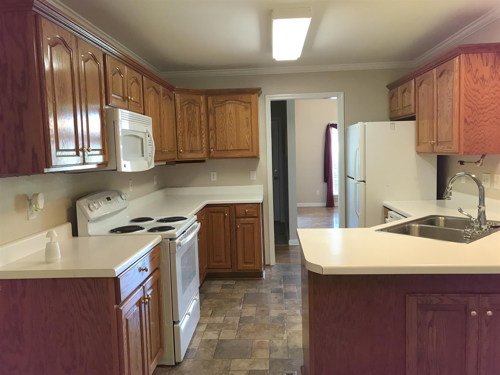 349 Duck River Road Manchester, TN 37355 - Photo 3 of 18 a kitchen with a sink stove and refrigerator