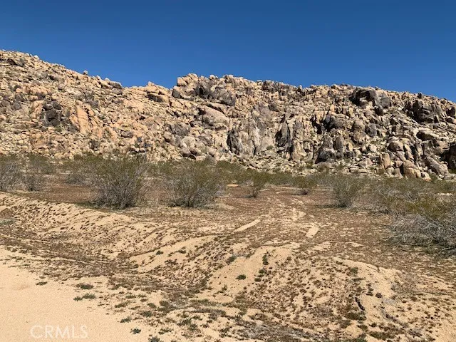 a view of a large building with a yard in the background