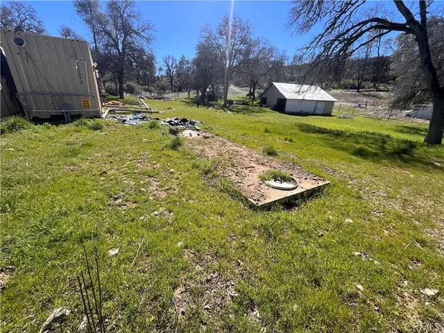 a backyard of a house with yard and trampoline